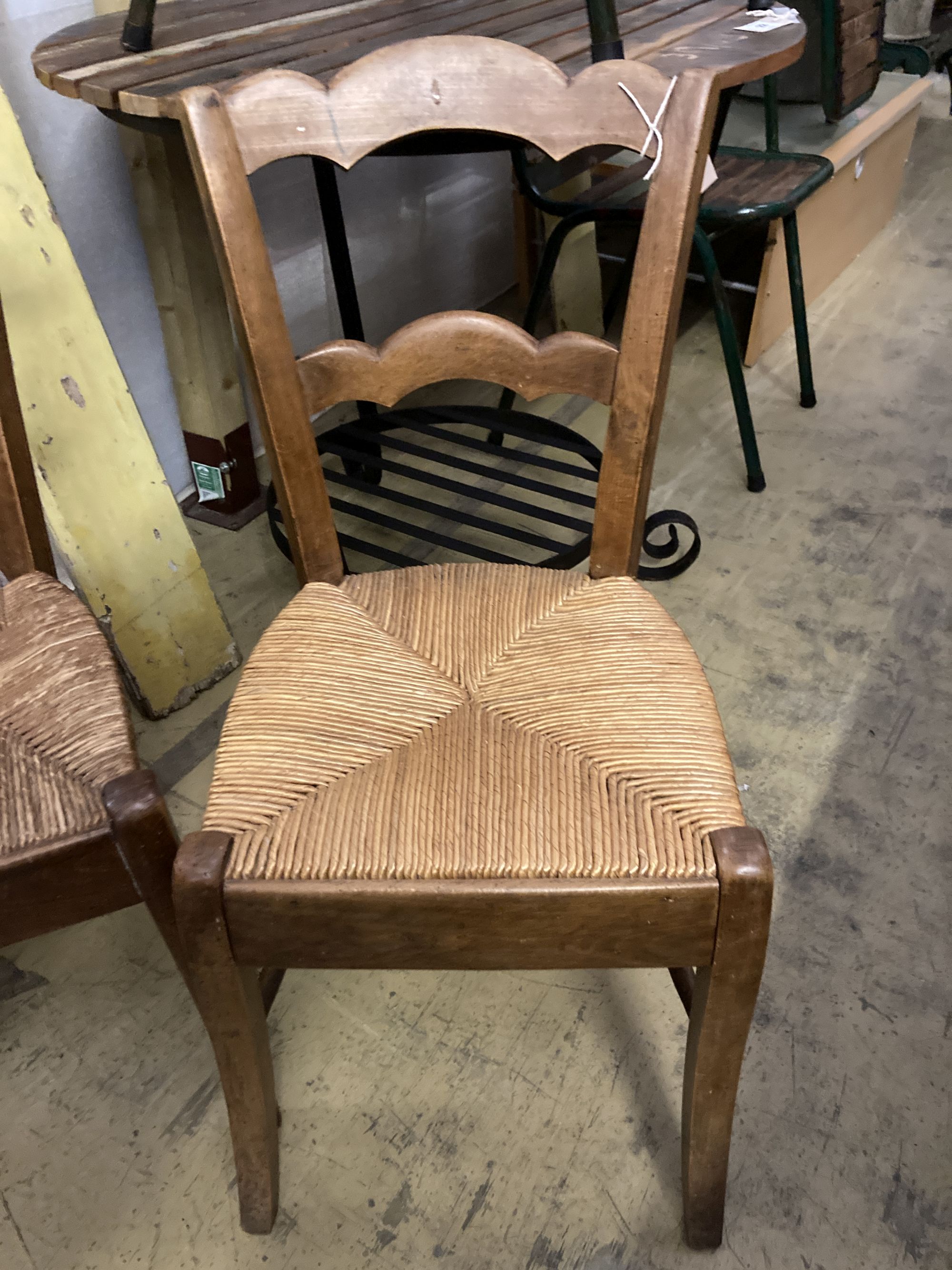 A set of four 19th century French beech rush seat dining chairs